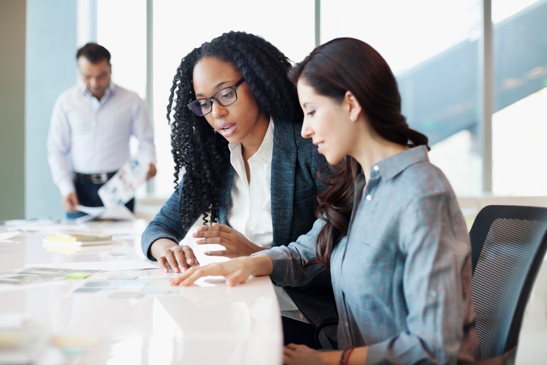 Woman discussing ideas with coworkers in office meeting